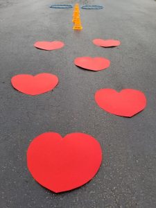 Fun Valentine's Day Obstacle Course for Kids Parties. It's easy to do with paper hearts, cones and hula hoops.