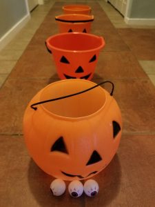 Fun Halloween Minute to Win It Game for kids, teens and adults. Challenge players to toss the ping pong balls into the plastic Halloween buckets in 60 seconds.