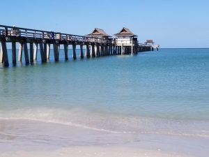 Historic Naples Pier is a free Naples attraction you can't miss while in Naples Florida. You'll love the stroll out into the ocean to watch the seagulls and even dolphins swim by. It's also a great spot to fish or have an ice cream with the kids. #naplespier #naplesflorida