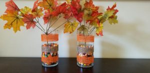 Create a DIY Fall Vase with fake leave and ribbon for your fall decorations using Dollar Tree items.