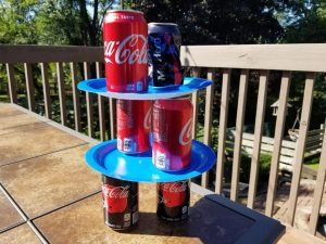 Minute to Win It game to stack soda cans and paper plates in 1 minute.