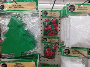 Make Dollar Tree crafts with kids at home using foam Christmas trees and green and red pom poms as your ball ornaments.
