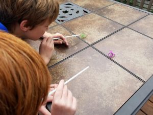Race Plastic Spiders across the table for a fun and easy Halloween game at home or at school parties.