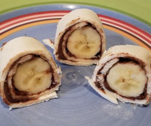 Banana Sushi - An Easy After School Snack for kids. Make this fast & healthy snack with tortilla, bananas and Nutella or peanut butter. Have a snack ready after school in minutes that's filling and delicious for kids. #easysnack #healthysnack #afterschoolsnack #bananasushi